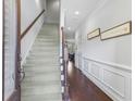 Inviting foyer with stairs and beautiful wainscoting adding elegance to the interior design at 2772 Archway Ln, Brookhaven, GA 30341