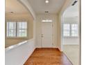 Bright foyer with hardwood floors, white trim, and views to other rooms through shuttered windows at 3411 Lindenridge Dr, Buford, GA 30519