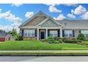 Charming brick townhome featuring a lush green lawn, tidy landscaping, and inviting curb appeal at 3411 Lindenridge Dr, Buford, GA 30519