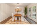 Bright dining room with wood table set and French doors, perfect for entertaining and Gathering meals at 607 Hickory Creek Ln, Woodstock, GA 30188