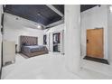 Stylish bedroom with tufted headboard, closet, and industrial ceiling features at 881 Memorial Se Dr # 116, Atlanta, GA 30316