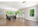 Bright dining area featuring hardwood floors, abundant natural light, and easy access to the outdoor patio through French doors at 1104 Fox Ln, Woodstock, GA 30188