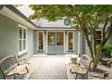 Charming front entrance with double doors, complemented by cozy benches and manicured landscaping, creating a welcoming ambiance at 1104 Fox Ln, Woodstock, GA 30188