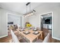 Modern dining room with neutral tones, wood floors, and stylish chandelier at 1139 Shiloh Nw Ln, Kennesaw, GA 30144