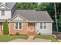 Welcoming home exterior showcasing an inviting front door with decorative glass, brick detail and landscaping at 1139 Shiloh Nw Ln, Kennesaw, GA 30144