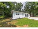 Lovely renovated one-story home showing a well-maintained lawn and inviting curb appeal on a sunny day at 2899 Gresham Se Rd, Atlanta, GA 30316