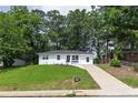 A charming one-story home with a lush green lawn and a freshly paved driveway for easy access at 2899 Gresham Se Rd, Atlanta, GA 30316