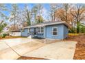 Side view of blue ranch-style home with spacious driveway and minimal landscaping at 2899 Gresham Se Rd, Atlanta, GA 30316