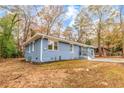 Blue ranch-style home side view featuring updated landscaping and fresh exterior paint at 2899 Gresham Se Rd, Atlanta, GA 30316