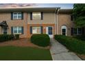 Charming townhome with brick and siding, offering a well-manicured lawn and inviting entrance at 406 Northdale Ct, Lawrenceville, GA 30046