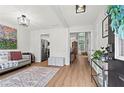 Inviting entryway with hardwood floors, a decorative rug, and an open view into the living spaces at 585 Ashland Pkwy, Woodstock, GA 30189