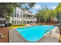 Inviting backyard pool with sun loungers and a spacious patio area for entertaining at 650 Garden Wilde Pl, Roswell, GA 30075