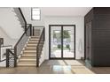 Staircase in entry hall featuring iron railings, wood stairs, and view to front yard at 13375 Fincher Rd, Canton, GA 30114