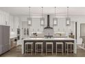 Modern kitchen with a large island, white cabinets, and stylish pendant lighting at 13375 Fincher Rd, Canton, GA 30114