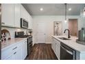 Well-equipped kitchen boasts white cabinetry, stainless steel appliances, and sleek countertops at 2038 Brookhill Way Lot 6, Snellville, GA 30078