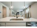 Modern kitchen features an island with quartz countertops, pendant lighting, and stainless steel appliances at 2038 Brookhill Way Lot 6, Snellville, GA 30078
