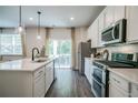 Bright kitchen featuring an island with bar seating and stainless steel appliances at 2038 Brookhill Way Lot 6, Snellville, GA 30078