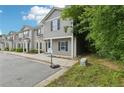 A view of townhomes featuring gray siding and dark blue doors accented by lush landscaping at 4001 Avalon Sw Rd, Atlanta, GA 30331