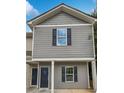 Detailed front view showcasing the gray siding, dark shutters, and covered porch of the townhome at 4001 Avalon Sw Rd, Atlanta, GA 30331