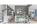 Inviting home foyer featuring decorative mirror, wooden floors, console table, and a staircase leading upstairs at 6317 Selborn Sw Dr, Atlanta, GA 30331