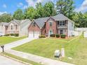 Beautiful brick home with a manicured lawn, driveway, and suburban neighborhood setting, perfect for families at 6317 Selborn Sw Dr, Atlanta, GA 30331