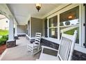Inviting front porch featuring classic rocking chairs and stone accents for a cozy welcome at 2565 Aaron Ct, Loganville, GA 30052