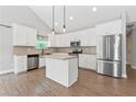 Modern kitchen with white cabinets, granite countertops, and stainless steel appliances at 2565 Aaron Ct, Loganville, GA 30052
