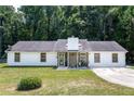 Charming single-story home features a well-maintained lawn and classic white siding and stone accents at 3385 Huntington Ct, Douglasville, GA 30134