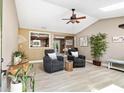 Inviting living room featuring vaulted ceilings, skylights, fan and a cozy seating arrangement at 3385 Huntington Ct, Douglasville, GA 30134