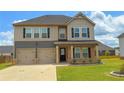 Charming two-story home featuring a two-car garage, neutral color palette, and well-manicured lawn at 89 Cowpen Ct, Covington, GA 30014