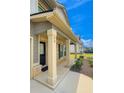 Welcoming covered front porch with sturdy columns, brick accents, and manicured landscaping at 89 Cowpen Ct, Covington, GA 30014