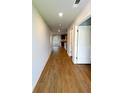 Bright hallway with beautiful wood flooring, neutral walls, and access to the kitchen at 89 Cowpen Ct, Covington, GA 30014