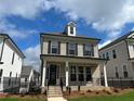 Charming two-story home with covered porch, gray brick, black shutters, and landscaped front yard at 163 Basil St, Cumming, GA 30040