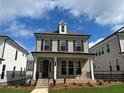 Charming two-story home featuring a brick facade, black shutters, and a welcoming front porch at 163 Basil St, Cumming, GA 30040