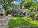 Charming home with a manicured lawn and mature trees providing shade at 2259 Eastway Rd, Decatur, GA 30033