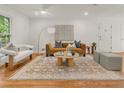 Bright living room featuring hardwood floors, a modern sofa, and stylish decor at 2259 Eastway Rd, Decatur, GA 30033