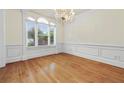 Dining room featuring hardwood floors, classic trim, a chandelier, and bright windows at 3450 Merganser Ln, Alpharetta, GA 30022