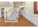 Spacious foyer with hardwood floors, staircase, and decorative moldings at 3450 Merganser Ln, Alpharetta, GA 30022