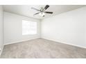 Neutral bedroom showcasing a ceiling fan, window, plush carpet, and ample natural light at 6481 Alford Way, Lithonia, GA 30058