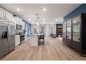 Modern kitchen featuring stainless steel appliances, white cabinets, and a spacious island with bar seating at 33 Cedar Dr, Fairburn, GA 30213