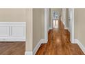 A view of the hallway with hardwood flooring and white trim at 3810 Baverton Dr, Suwanee, GA 30024