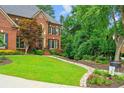 Beautiful brick home with lush lawn, landscaping and inviting walkway at 130 Silver Mist Cir, Alpharetta, GA 30022