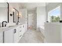 Elegant bathroom with dual sinks, marble floors, a soaking tub, and plenty of cabinet space at 133 Daxton Dr, Canton, GA 30115