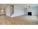 Bright living room with a fireplace, hardwood floors, and staircase leading to upper level at 247 Arnewood Cir, Mcdonough, GA 30253