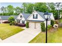Beautiful home featuring a well-maintained lawn and a spacious two-car garage at 1015 Buckeye Ln, Villa Rica, GA 30180
