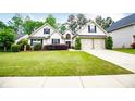 Charming home with a well-manicured lawn, lovely landscaping, and a two-car garage at 1015 Buckeye Ln, Villa Rica, GA 30180