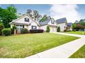Charming home with a well-manicured lawn, lovely landscaping, and a two-car garage at 1015 Buckeye Ln, Villa Rica, GA 30180