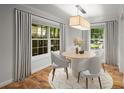 Charming dining room with a round table, modern lighting, and bright windows at 1384 N Crossing Ne Dr, Atlanta, GA 30329