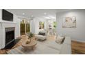 Bright living room with a fireplace, wood floors, and large windows overlooking backyard at 1384 N Crossing Ne Dr, Atlanta, GA 30329