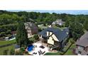 Aerial view showcases the backyard oasis featuring a pool, patio, and lush landscaping at 154 Gold Leaf Trail Trl, Powder Springs, GA 30127